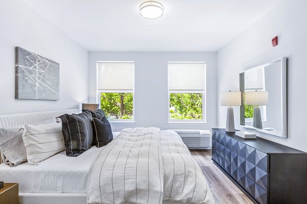 Cozy bedroom with modern furnishings at The Park at Woodbridge Station Apartments, ideal for comfort and relaxation