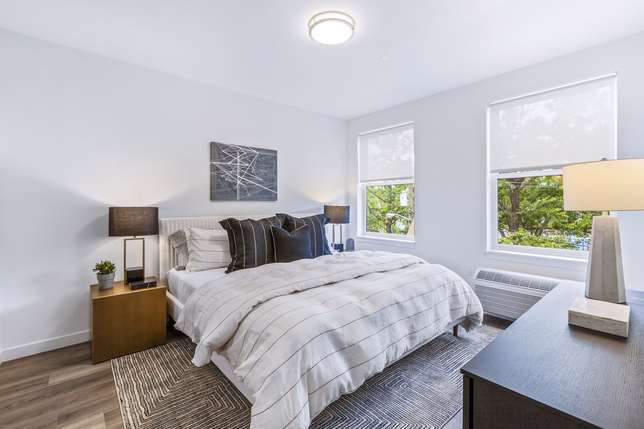 Elegant bedroom featuring modern decor at The Park at Woodbridge Station Apartments