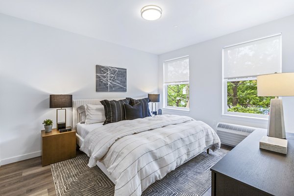 Elegant bedroom featuring modern decor at The Park at Woodbridge Station Apartments
