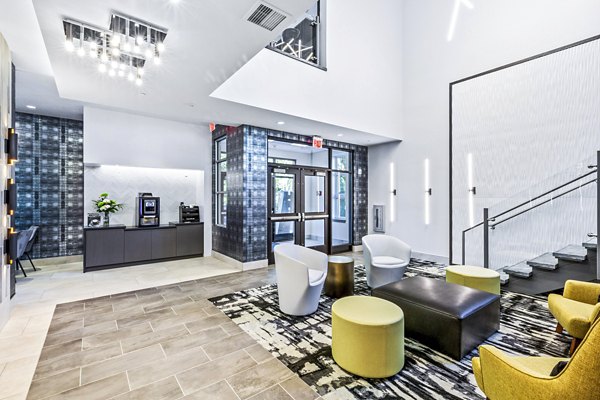 Clubhouse lobby featuring modern furnishings and cozy seating at The Park at Woodbridge Station Apartments