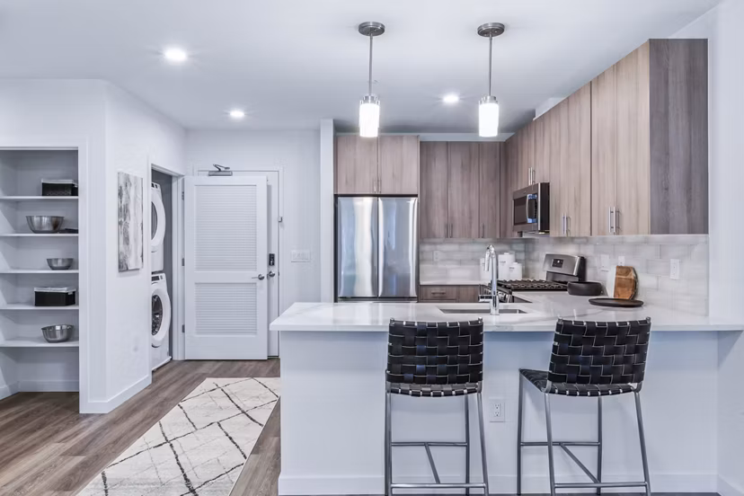 Modern kitchen with stainless steel appliances at The Park at Woodbridge Station Apartments
