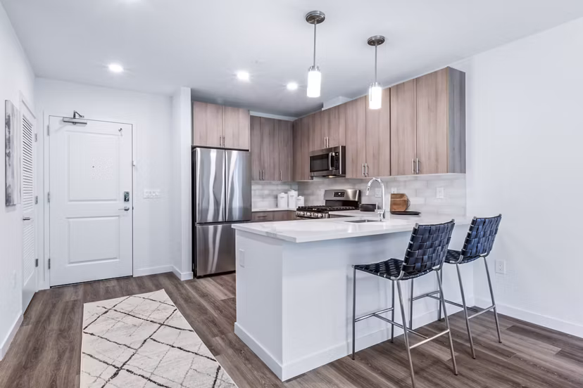 Modern kitchen with sleek countertops and stainless steel appliances at The Park at Woodbridge Station Apartments