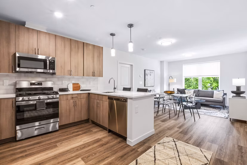 Modern kitchen with stainless steel appliances at The Park at Woodbridge Station Apartments