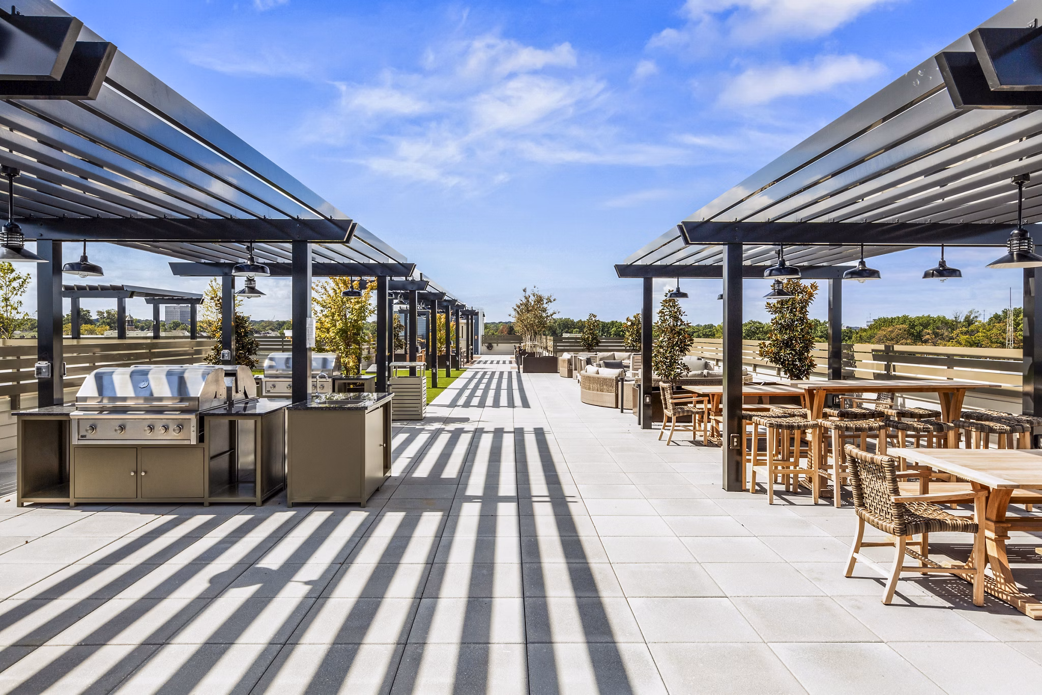 Outdoor grill area on stylish patio at The Park at Woodbridge Station Apartments offering casual dining and leisure space