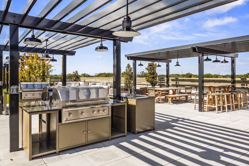 Outdoor grill area on scenic patio at The Park at Woodbridge Station Apartments, ideal for luxury living and leisure