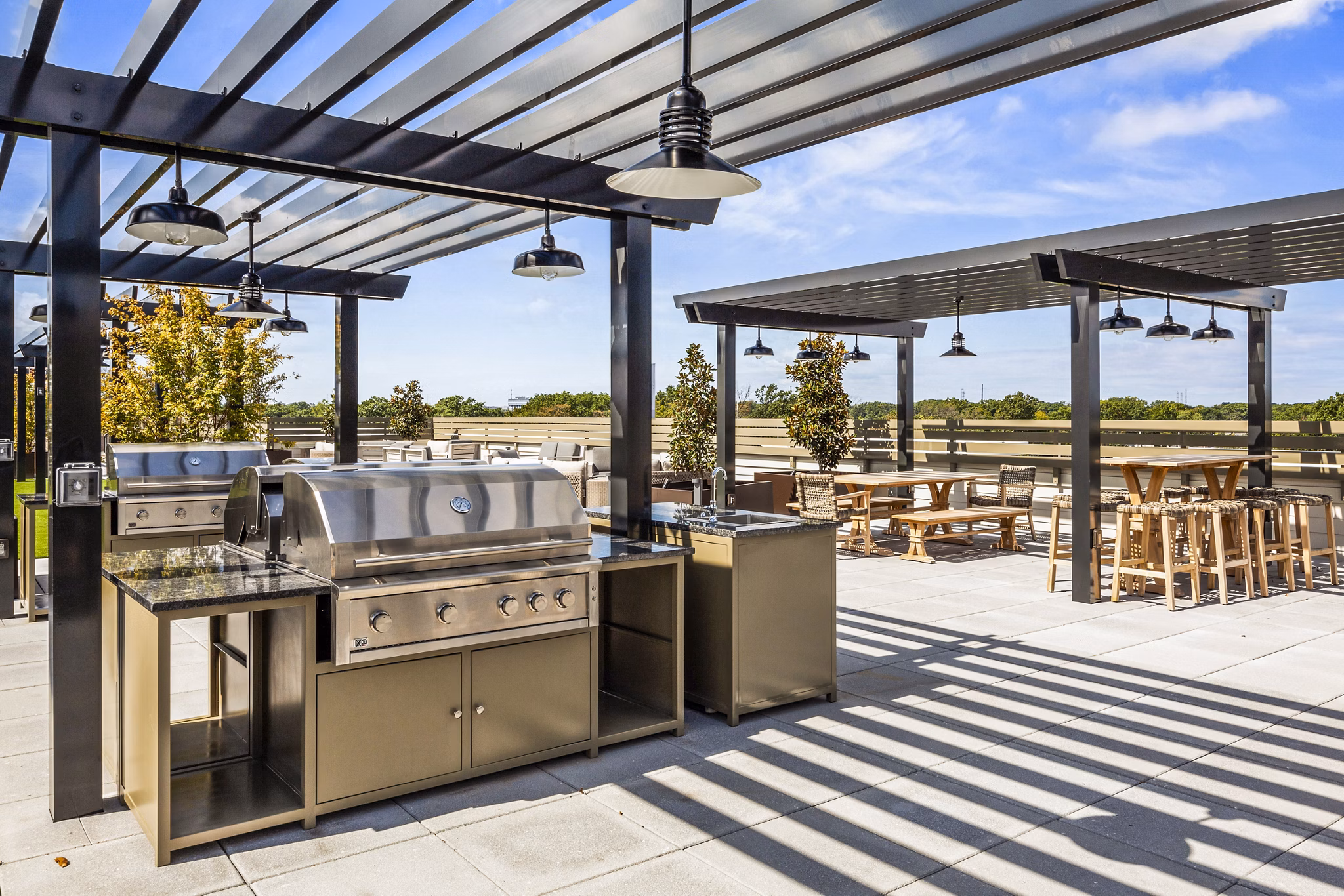 Outdoor grill area on scenic patio at The Park at Woodbridge Station Apartments, ideal for luxury living and leisure