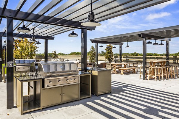 Outdoor grill area on scenic patio at The Park at Woodbridge Station Apartments, ideal for luxury living and leisure