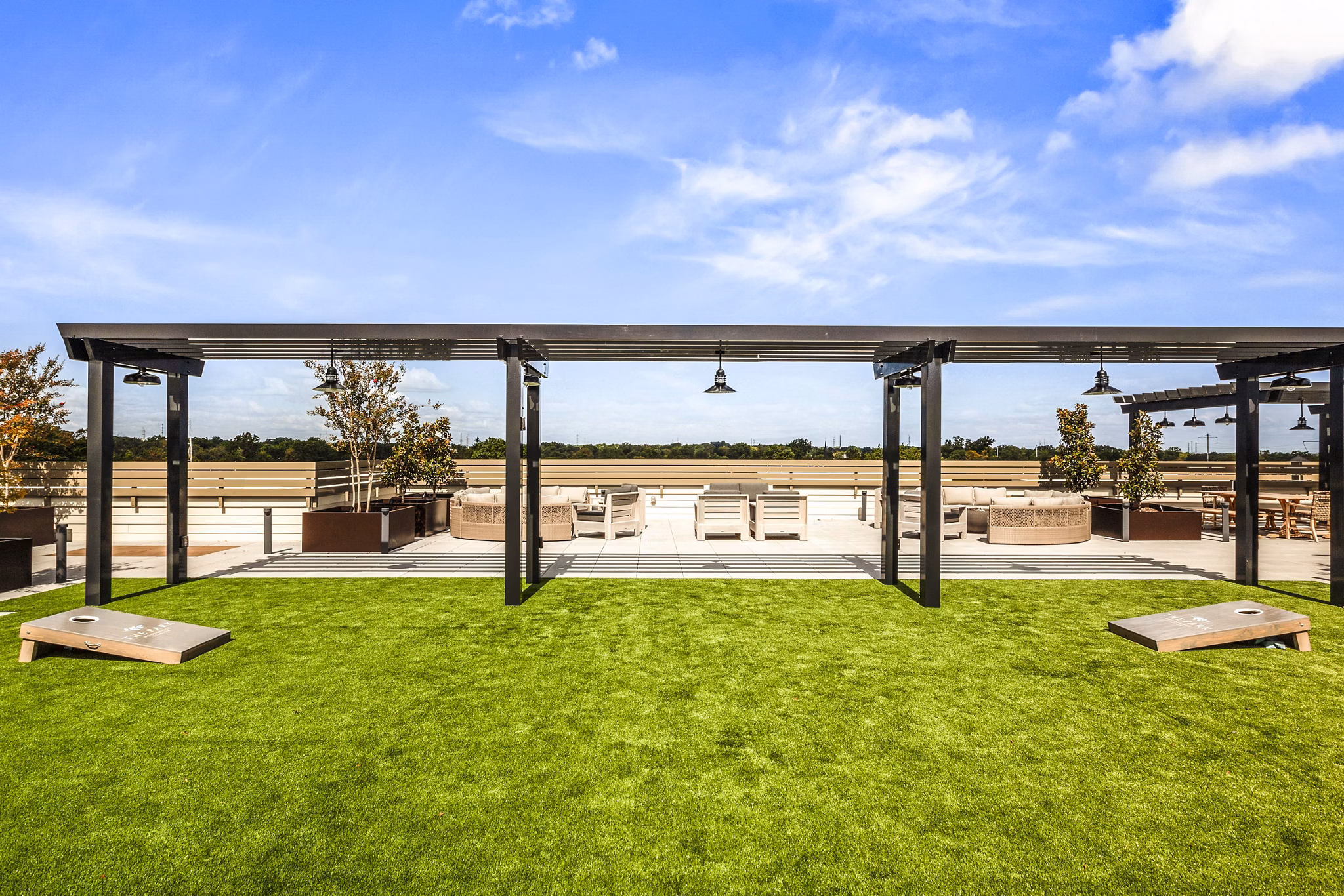 Outdoor recreational area with lush greenery at The Park at Woodbridge Station Apartments, ideal for relaxation and leisure activities