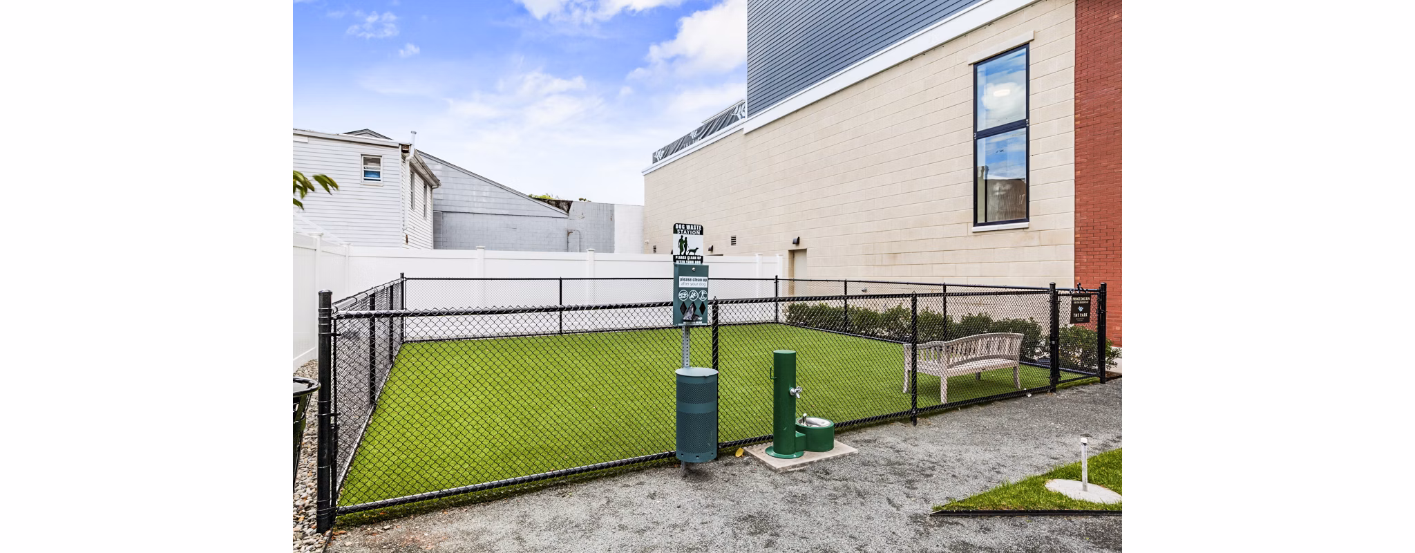Fenced dog park with agility equipment at The Park at Woodbridge Station Apartments