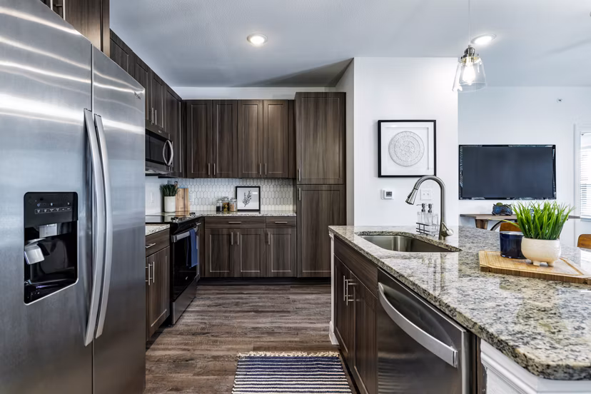 Modern kitchen with stainless steel appliances at Cadence Creek at Gosling Apartments