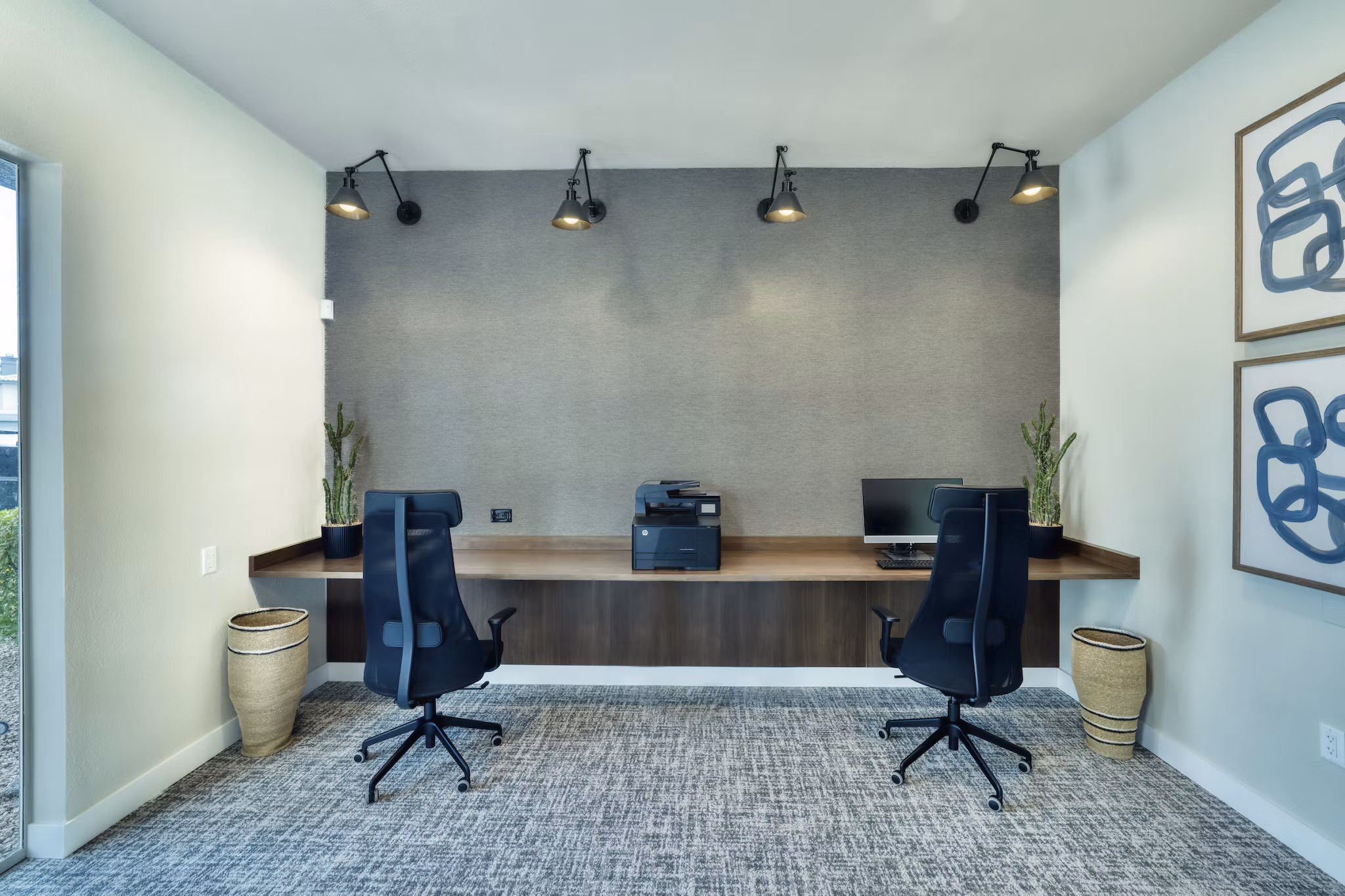 Business center with sleek workstations and modern technology at Mountainside Apartments