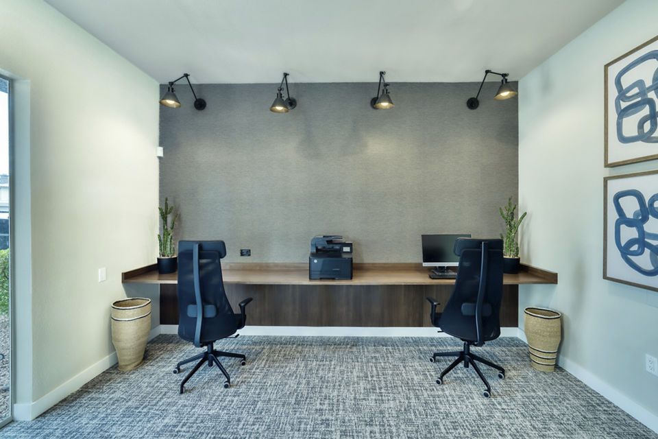 Business center with sleek workstations and modern technology at Mountainside Apartments