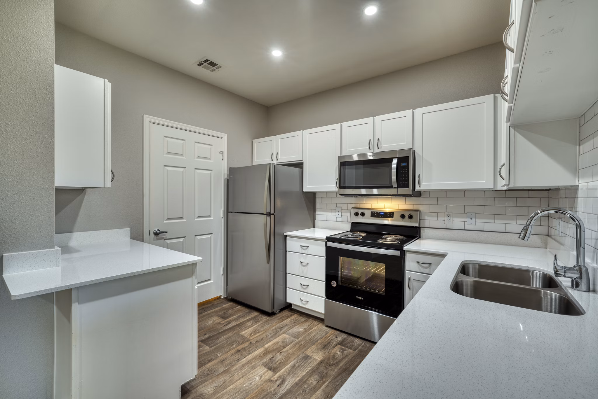 Modern kitchen with stainless steel appliances and marble countertops in Mountainside Apartments, a luxury property by Greystar