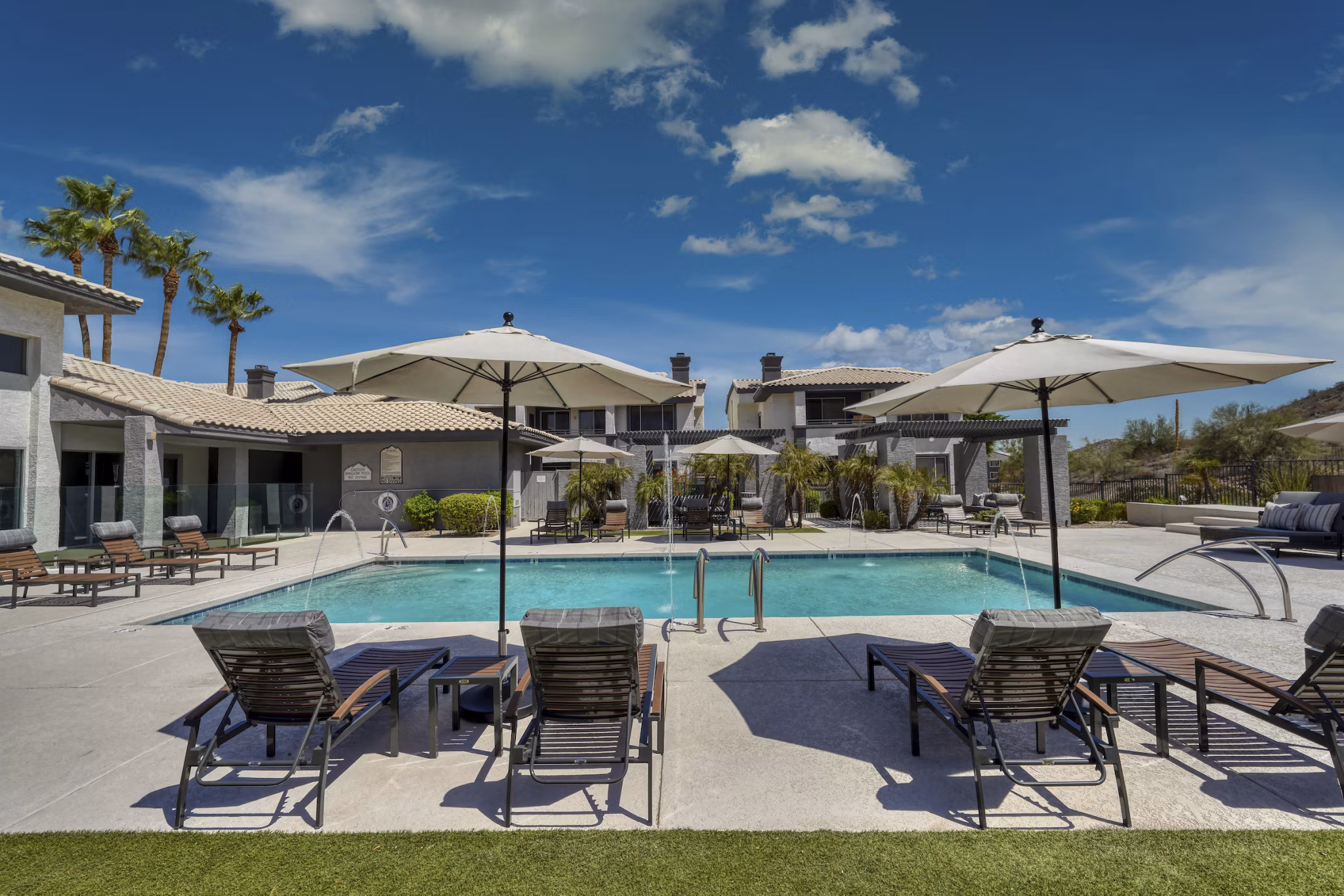 Outdoor pool with mountain views at Mountainside Apartments