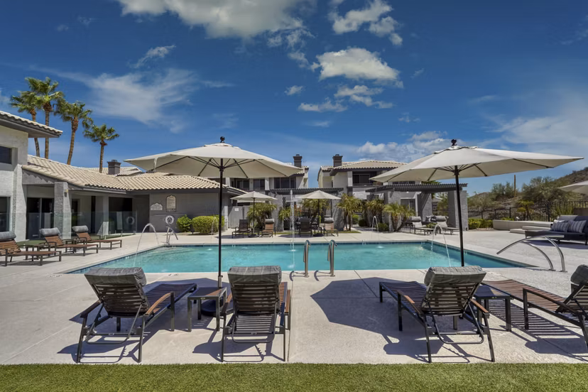 Outdoor pool with mountain views at Mountainside Apartments