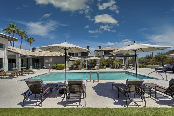 Outdoor pool with mountain views at Mountainside Apartments