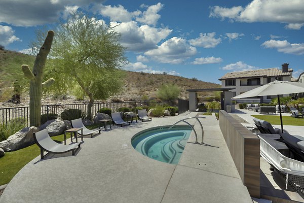 Relaxing jacuzzi with stunning mountain views at Mountainside Apartments