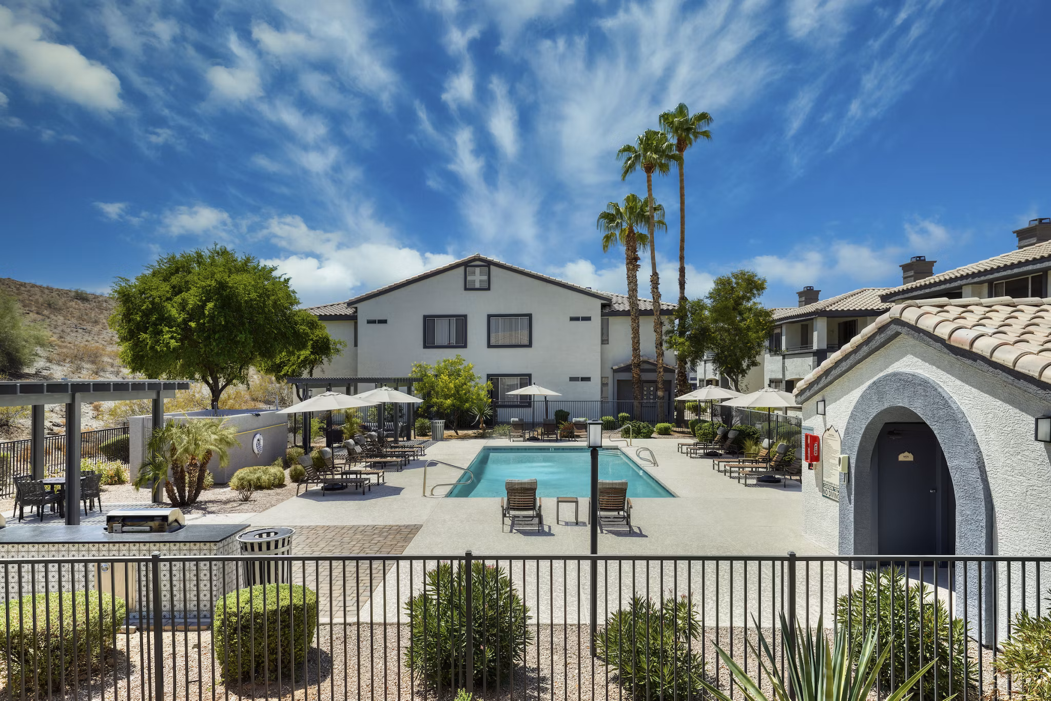 Luxurious outdoor pool at Mountainside Apartments with scenic mountain views, ideal for relaxation and leisure activities