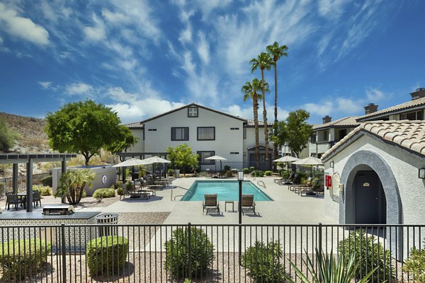 Luxurious outdoor pool at Mountainside Apartments with scenic mountain views, ideal for relaxation and leisure activities