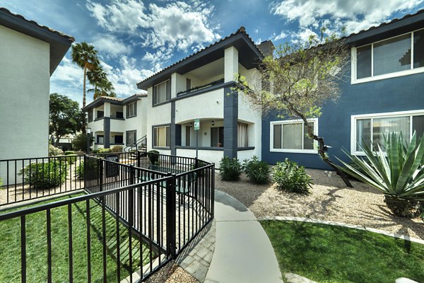 Dog-friendly park with open lawn and agility equipment at Mountainside Apartments