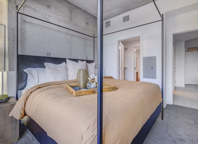 Spacious bedroom with modern furnishings at The Charles Apartments, luxury living by Greystar