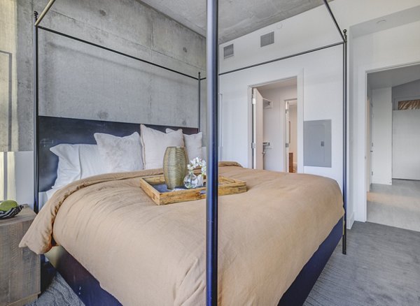 Spacious bedroom with modern furnishings at The Charles Apartments, luxury living by Greystar
