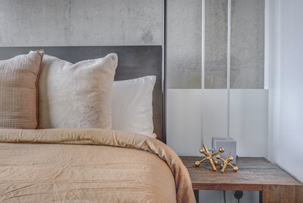 Cozy bedroom with modern furnishings at The Charles Apartments