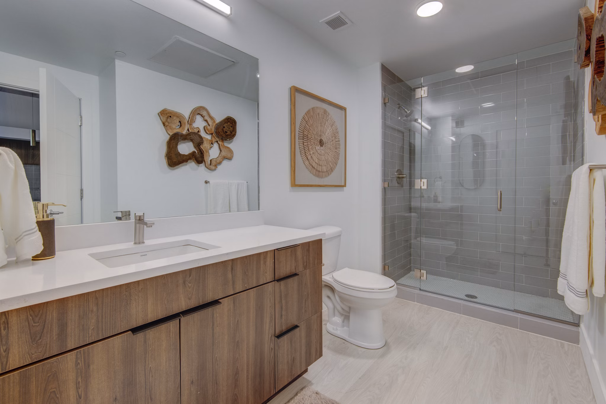 Elegant bathroom featuring marble countertops and modern fixtures in The Charles Apartments