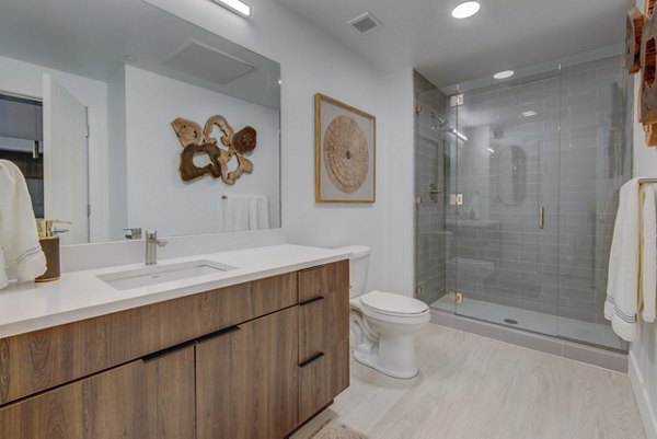 Elegant bathroom featuring marble countertops and modern fixtures in The Charles Apartments
