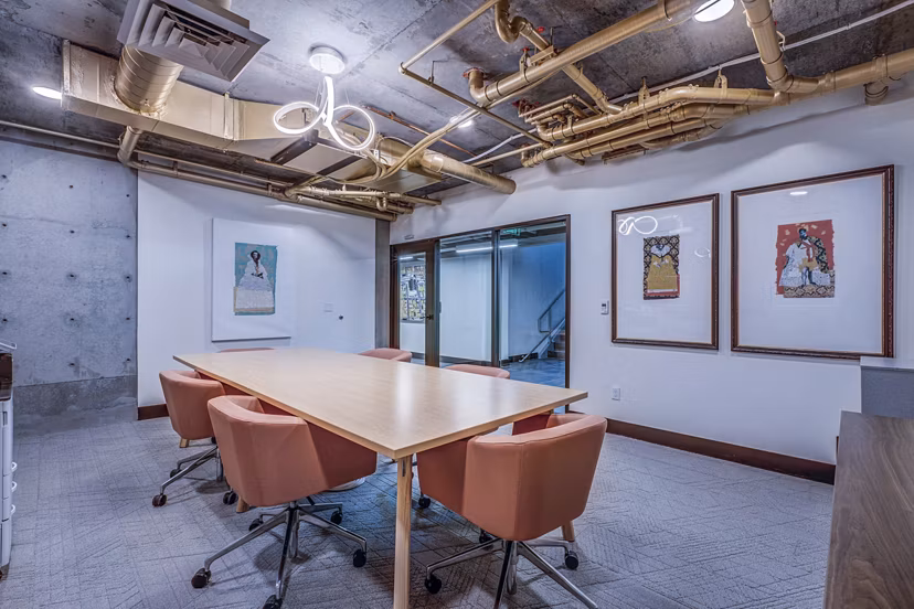 Clubhouse meeting facility with modern seating and amenities at The Charles Apartments