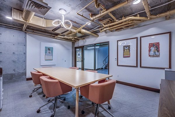 Clubhouse meeting facility with modern seating and amenities at The Charles Apartments