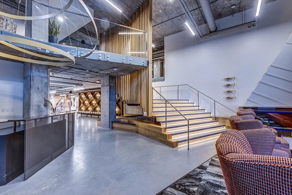 Clubhouse lobby featuring elegant decor and ample seating at The Charles Apartments