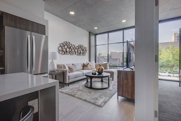 Modern kitchen with sleek countertops and stainless steel appliances in The Charles Apartments