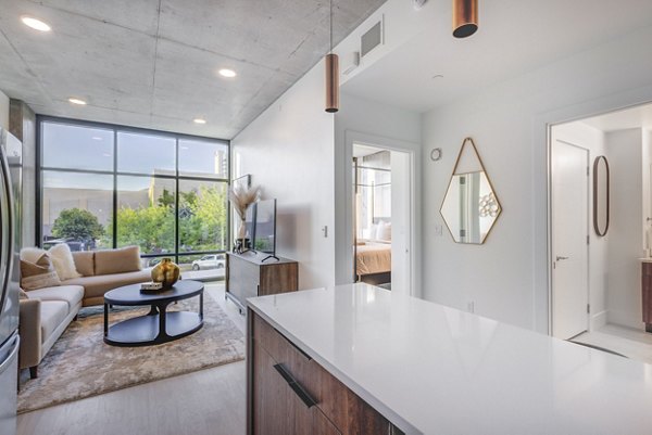 Chic kitchen with stainless steel appliances and granite countertops in The Charles Apartments