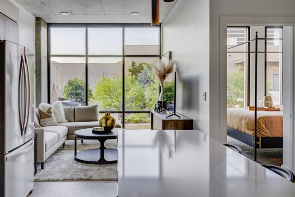Spacious kitchen with modern appliances and quartz countertops in The Charles Apartments