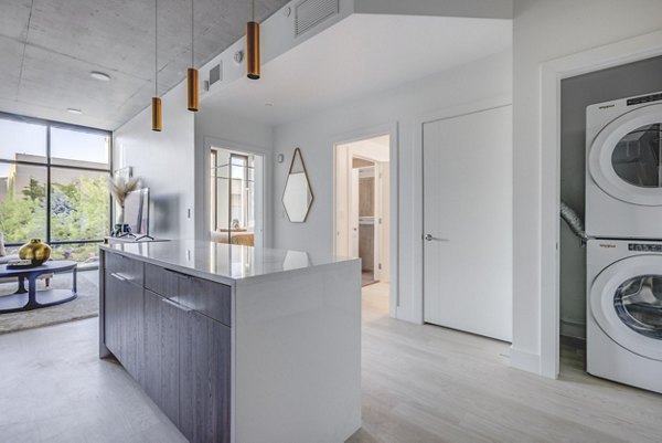 Modern kitchen with stainless steel appliances in The Charles Apartments, offering luxury living in a premium urban setting