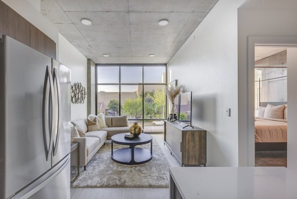 Modern kitchen with sleek countertops and stainless steel appliances at The Charles Apartments