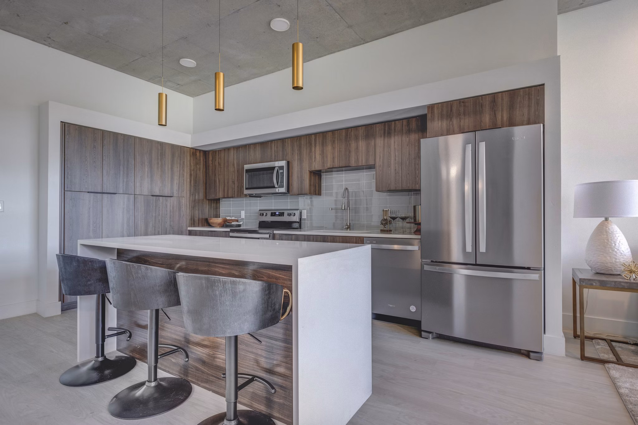 Modern kitchen with sleek design and stainless steel appliances at The Charles Apartments