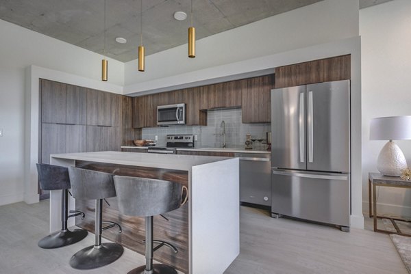 Modern kitchen with sleek design and stainless steel appliances at The Charles Apartments