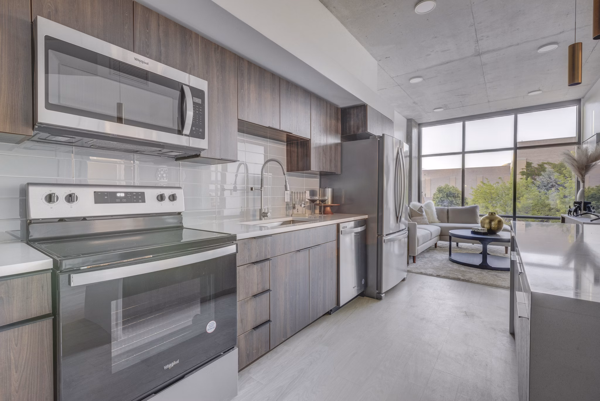 Modern kitchen featuring sleek countertops and stainless steel appliances at The Charles Apartments