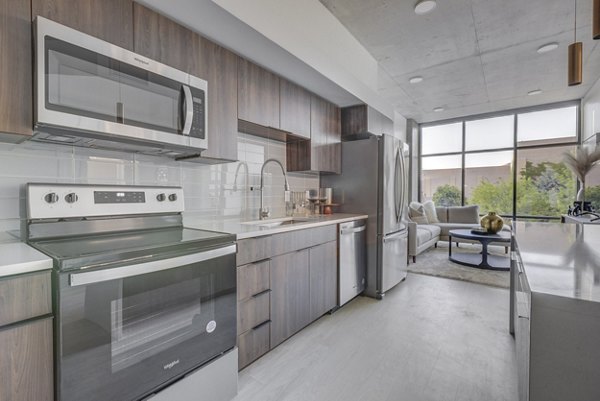 Modern kitchen featuring sleek countertops and stainless steel appliances at The Charles Apartments