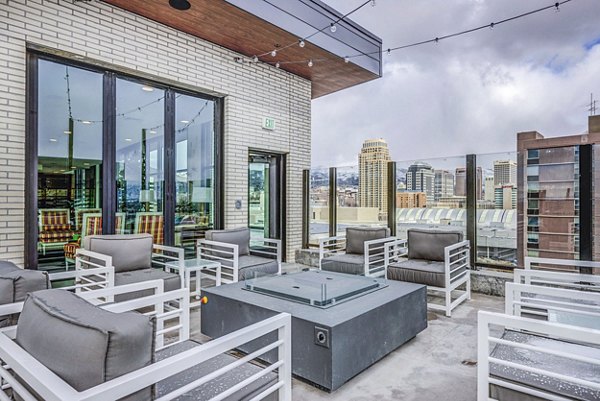 The Charles Apartments: Cozy patio with fire pit, perfect for relaxation and social gatherings in a vibrant community setting