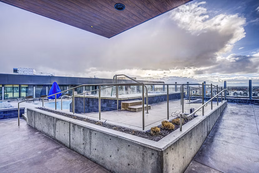 Luxurious hot tub at The Charles Apartments offering relaxation and comfort with scenic views