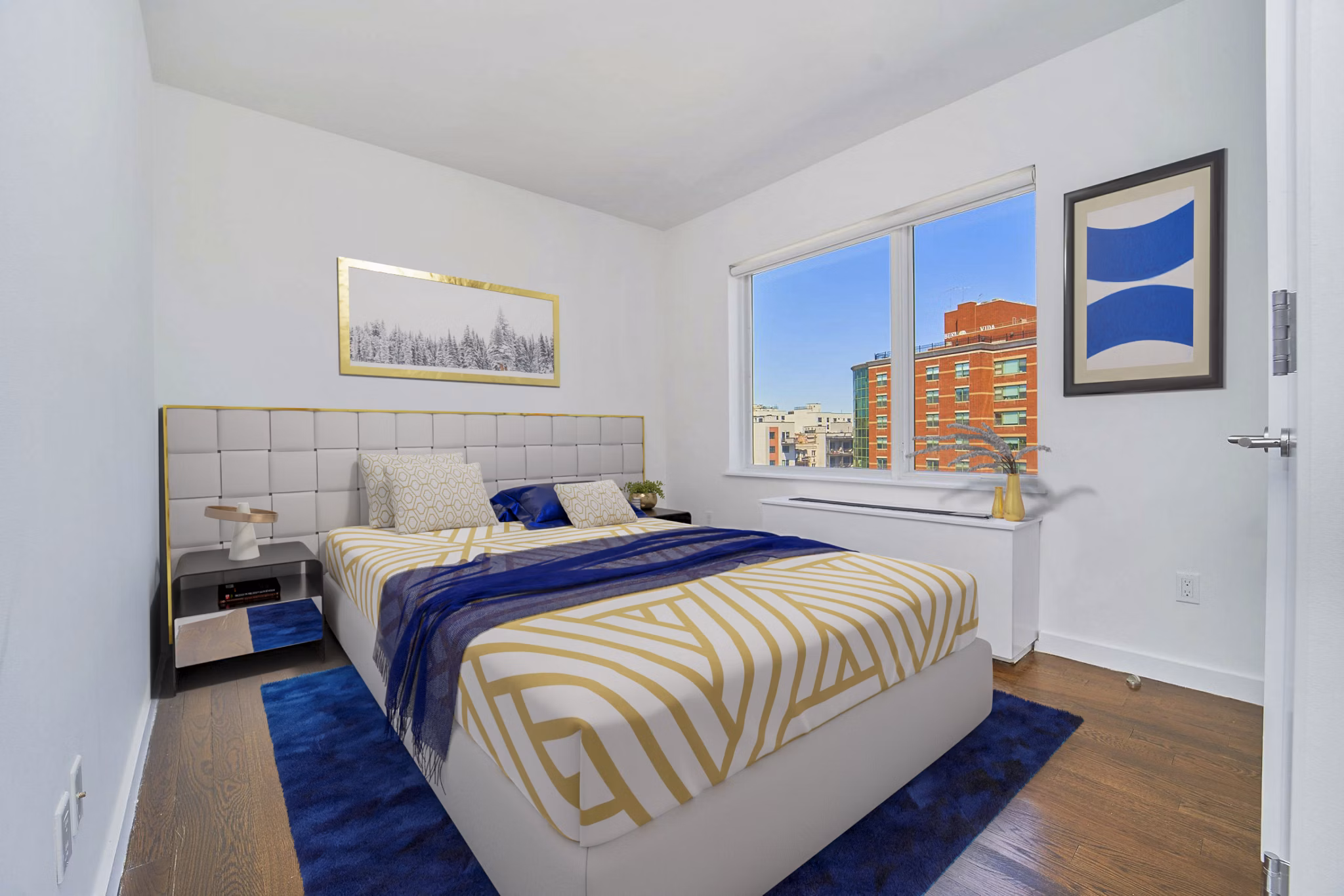 Modern bedroom with plush bedding and large windows at 1209 Dekalb Apartments, a Greystar luxury community