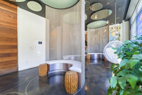 Clubhouse lobby with modern furnishings and bright lighting at 1209 Dekalb Apartments