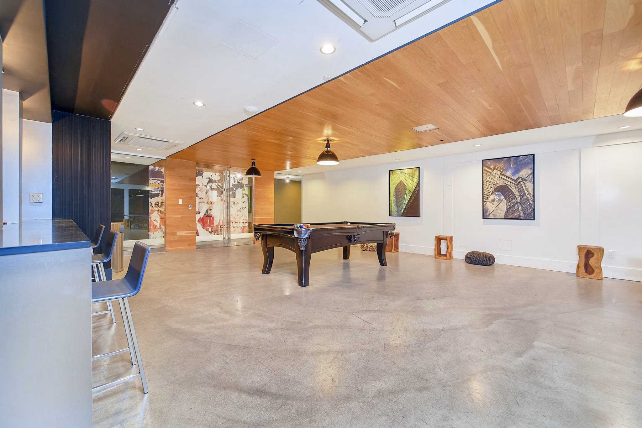 Clubhouse game room featuring pool table and lounge seating at 1209 Dekalb Apartments, offering modern luxury amenities