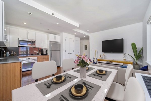 Dining room with modern furnishings at 1209 Dekalb Apartments featuring elegant wooden table and chairs