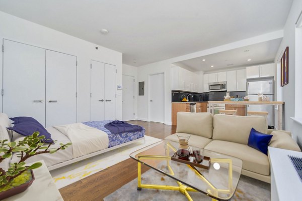 Modern studio living room with sleek furnishings at 1209 Dekalb Apartments in Brooklyn, NY.