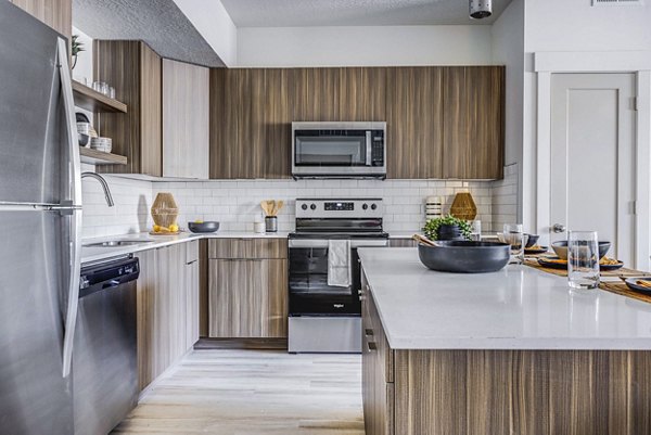 Modern kitchen with stainless steel appliances at Bravada 193 Apartments