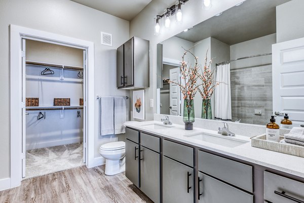 Bathroom featuring chic marble countertops and modern fixtures at Moderno Apartments